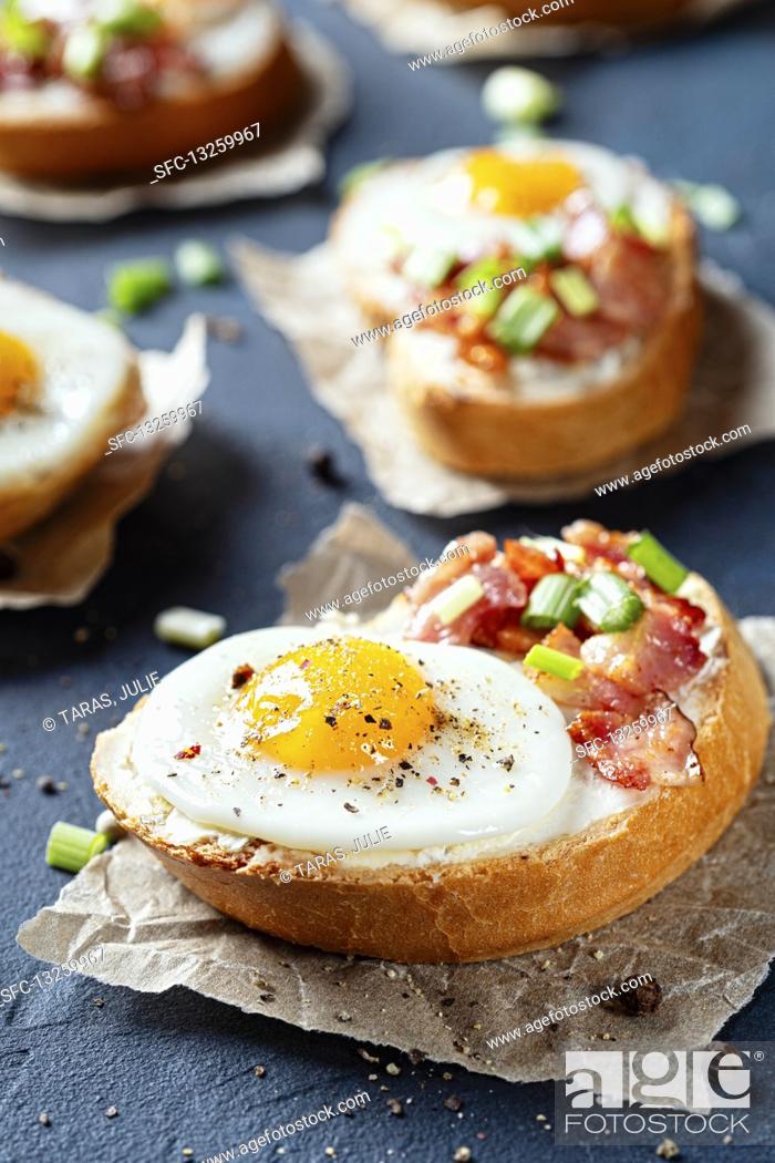 Stock Photo: Crostini with bacon, spring onions and quail's eggs.