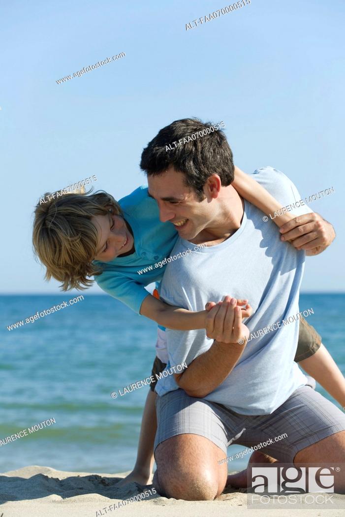 Stock Photo: Father and son having fun together at the beach.