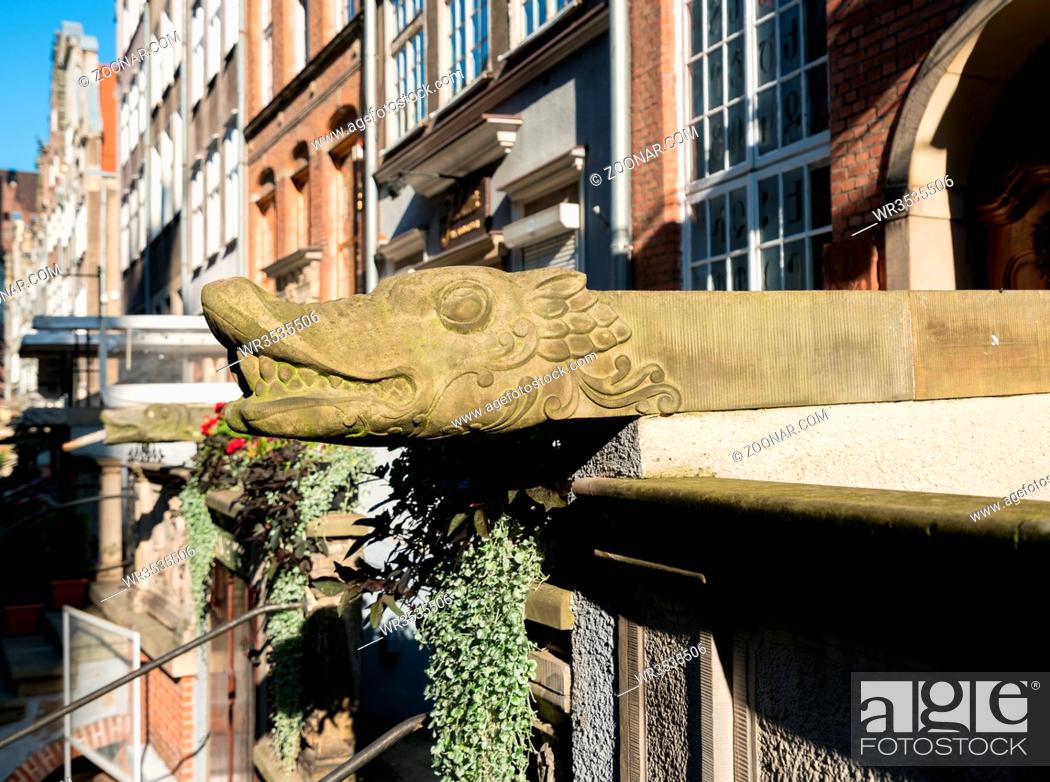 Stock Photo: Stone carved head of dragon as water spout or gutter of home on Mariacka St in Gdansk, Poland.