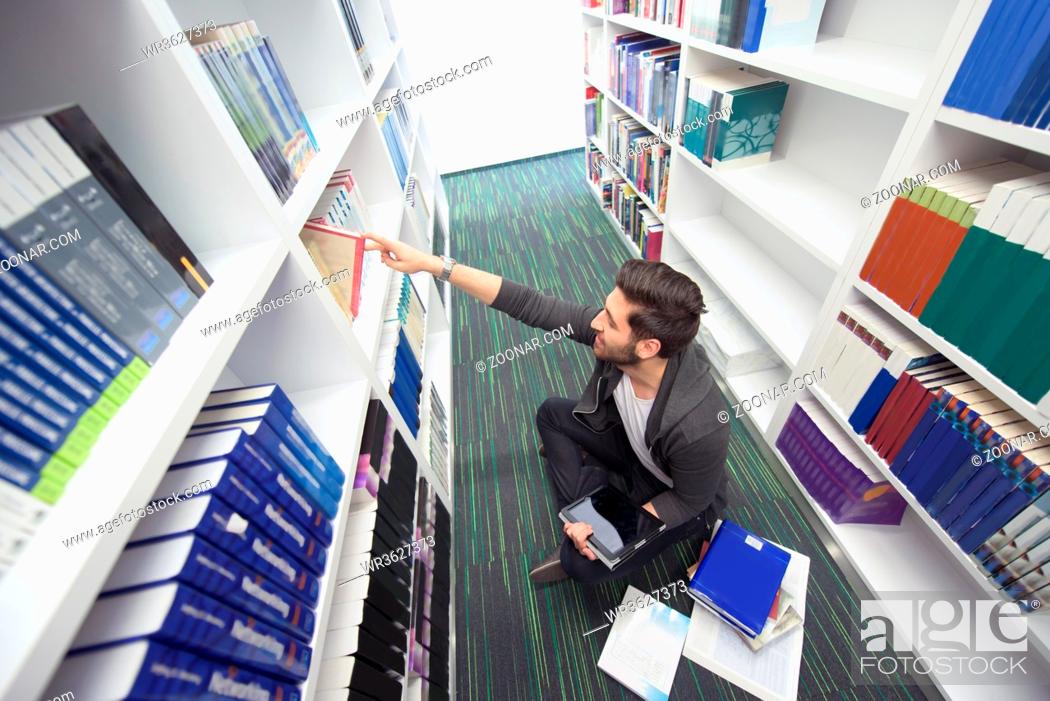 Stock Photo: Student reading book in school library. Study lessons for exam. Hard worker and persistance concept.