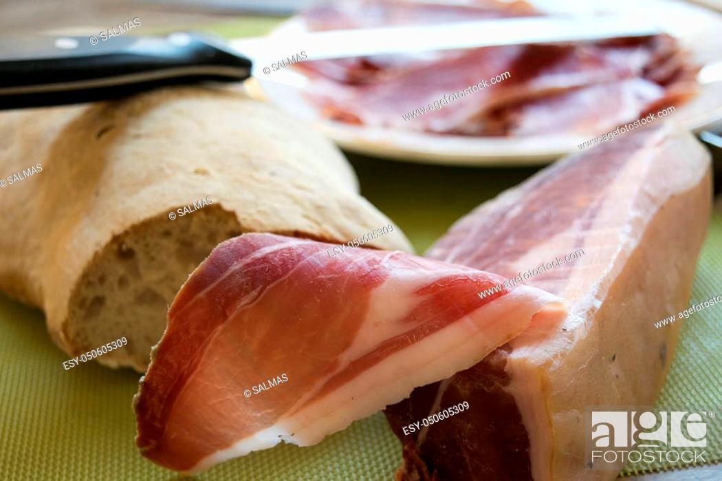 Stock Photo: famous Italian dry-cured ham called prosciutto di parma cut by hand.