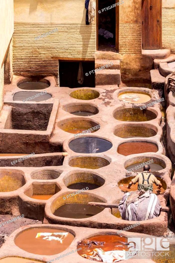 Stock Photo: Fes el Bali worker the dye pots at leather traditional tanneries in the ancient medina, in Fez, Morocco.
