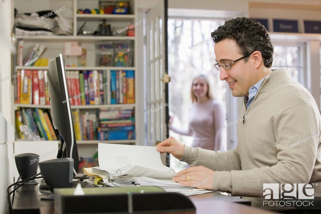 Stock Photo: Hispanic businessman working in a home office.