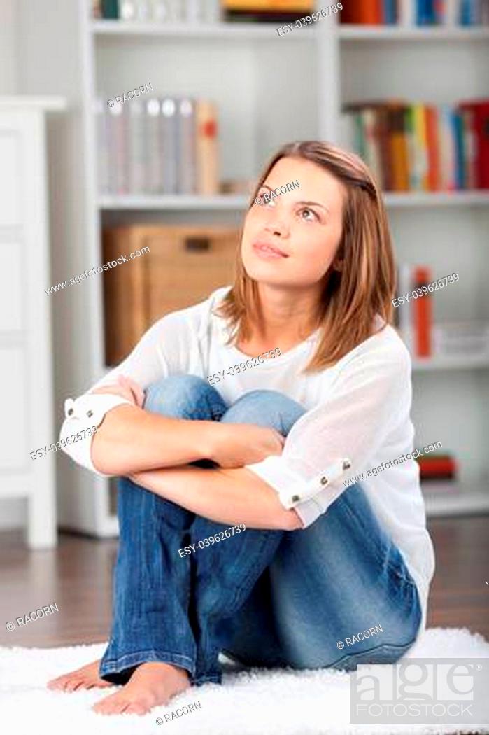 Stock Photo: Profile of a pretty young woman looking up and thinking about something.