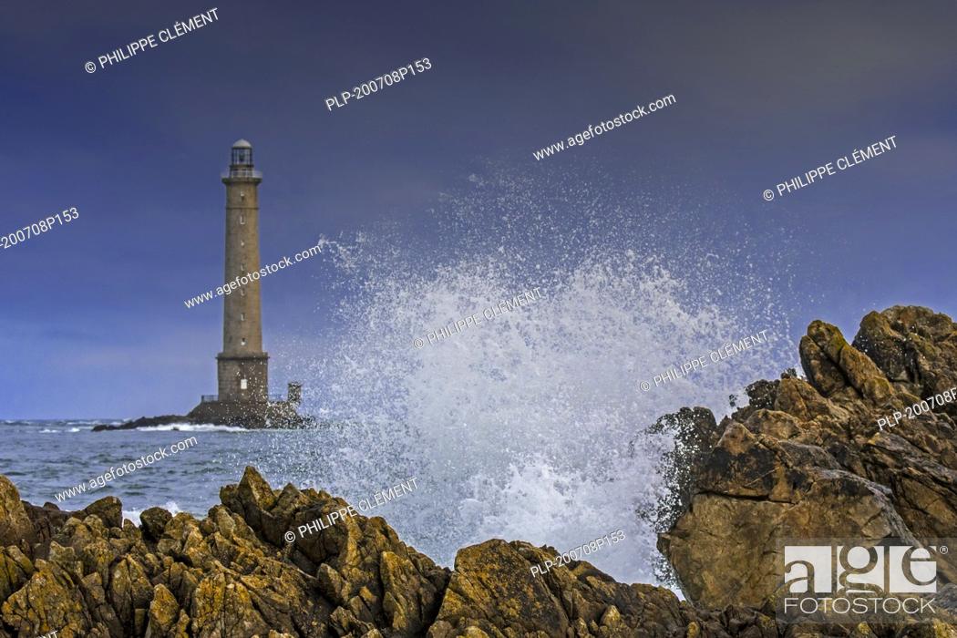 Stock Photo: Wave crashing on rock and Phare de La Hague / Phare de Goury lighthouse near Auderville, Cap de La Hague, Cotentin peninsula, Lower Normandy, France.