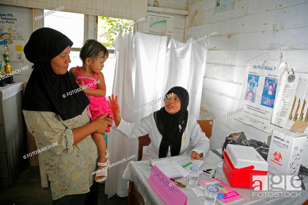 Stock Photo: people child person indonesia nurse examining.