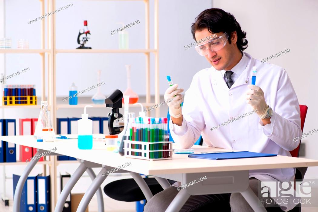 Stock Photo: Young handsome chemist working in the lab.
