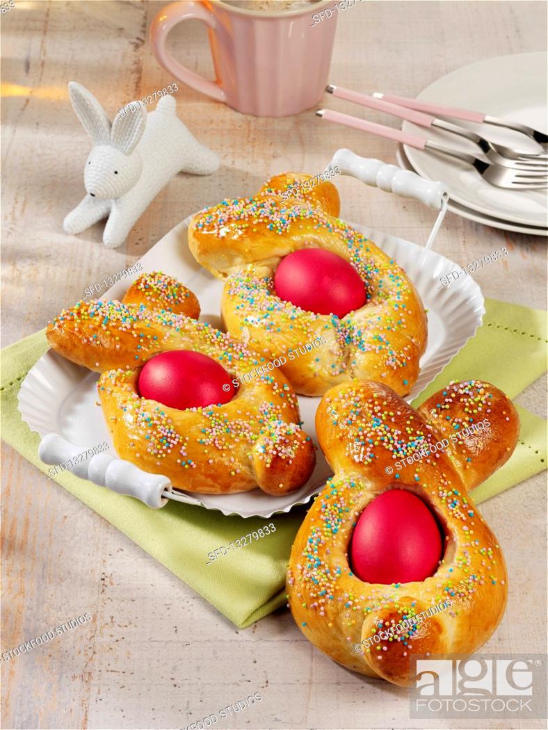 Stock Photo: Yeast Easter bunnies with colorful Easter eggs.
