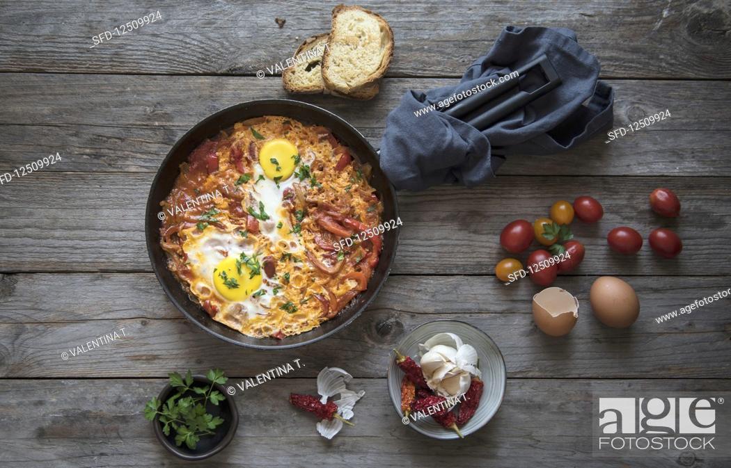 Stock Photo: Shakshuka with tomatoes, peppers, onions and eggs.