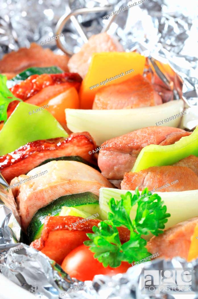 Stock Photo: Pork and vegetable skewers in aluminum foil.