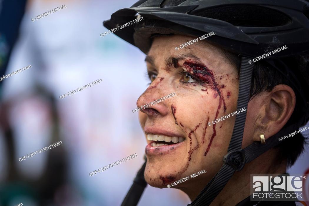 Stock Photo: German cyclist Sabine Spitz in the finish of Stage 1 of Cape Epic mountain bike stage race in South Africa. Her eyebrow needed 7 stitches after crash.