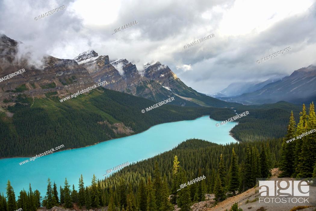 Stock Photo: Cloudy mountain peaks, turquoise glacial lake surrounded by forest, Peyto Lake, Rocky Mountains, Banff National Park, Alberta Province, Canada, North America.