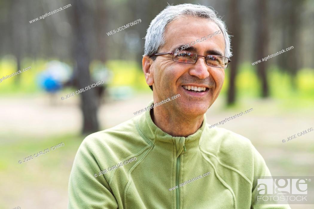 Stock Photo: Happy mature man wearing eyeglasses in forest.