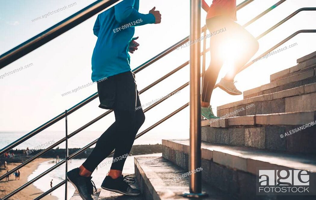 Stock Photo: View of runners legs training outdoor - Young couple doing a workout session on stairs next the beach at sunset - Healthy people.