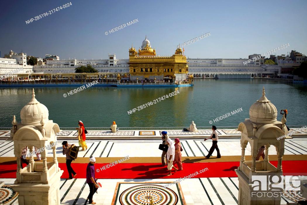 Stock Photo: The Golden Temple Hari Mandir Sahib in the middle of the Sacred Pool, Amrit Sarovar Pool of Nectar, seen in early-morning light.