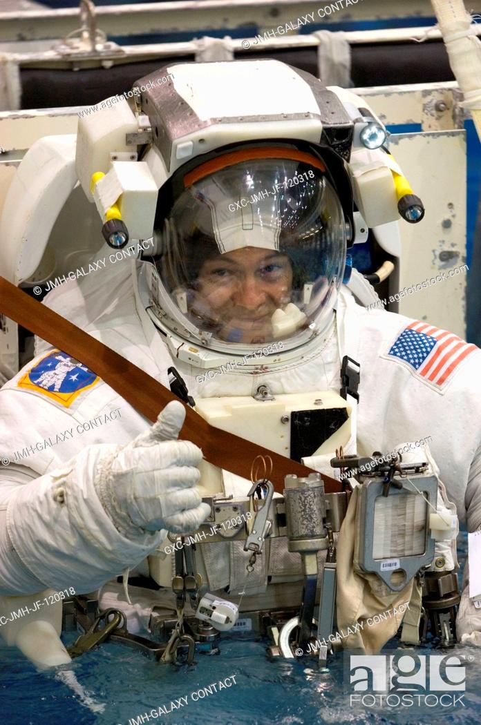 Stock Photo: Astronaut Michael E. Lopez-Alegria, Expedition 14 commander and NASA space station science officer, gives a thumbs-up signal while being submerged in the waters.
