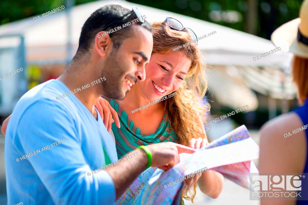 Stock Photo: Friends with a map.