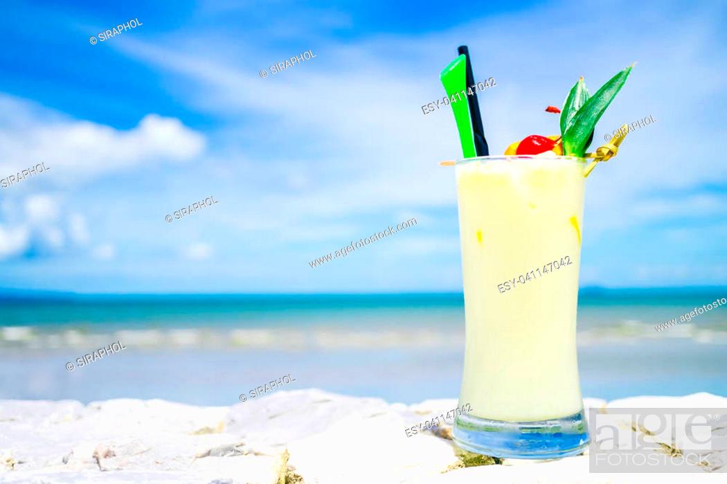 Stock Photo: Ice drinking cocktails glass with ocean and sea on blue sky background - Color Filter Processing.