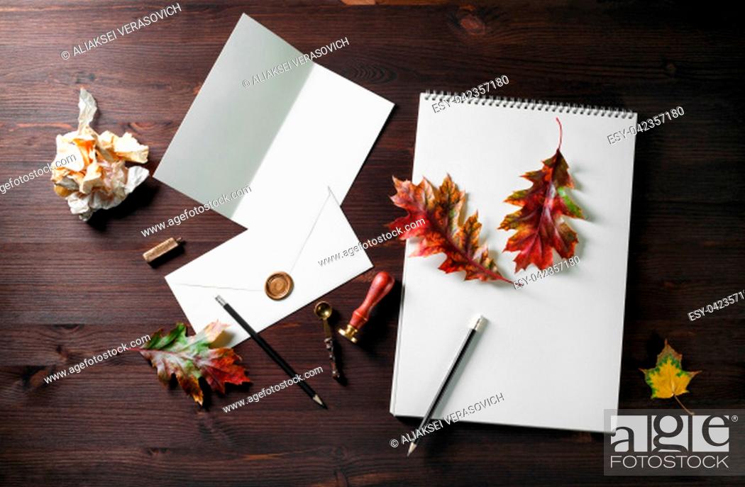 Stock Photo: Vintage stationery and autumn leaves on dark wooden background. Responsive design mockup. Flat lay.