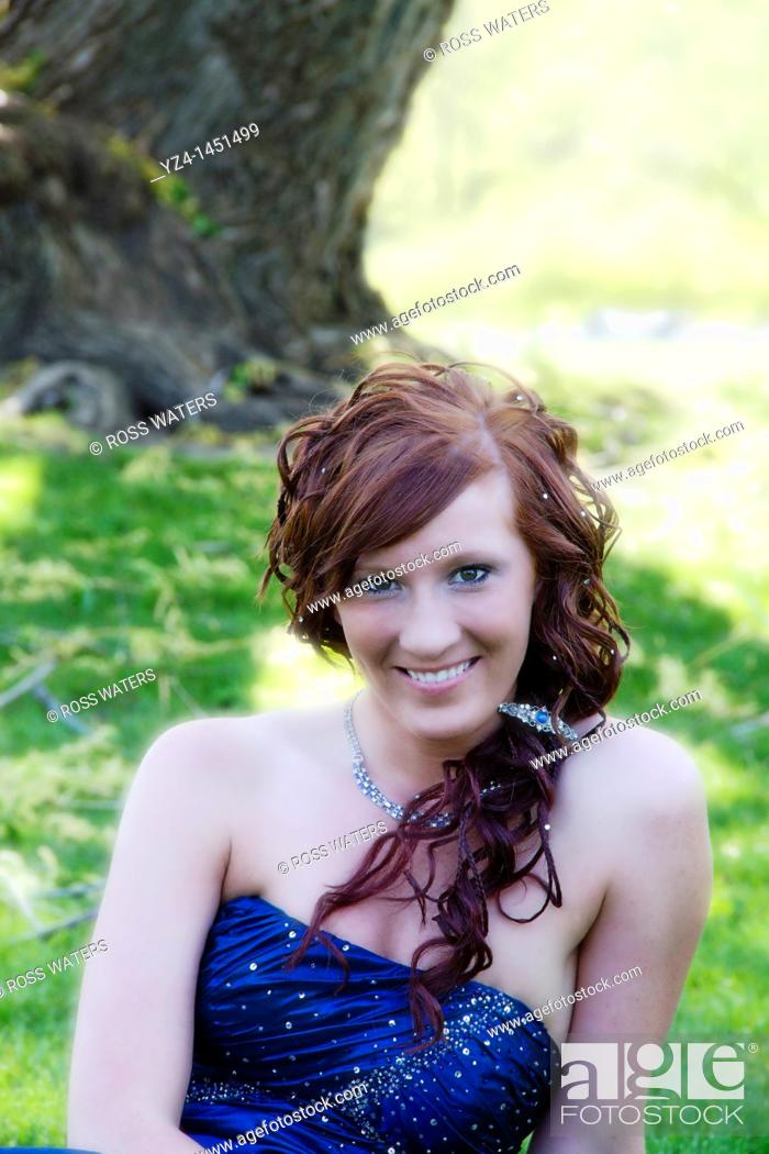 Stock Photo: A young female high school student in a prom dress outdoors.