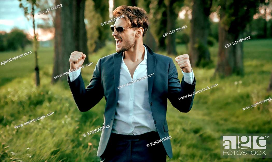 Stock Photo: Portrait of a handsome, young businessman close to the nature.