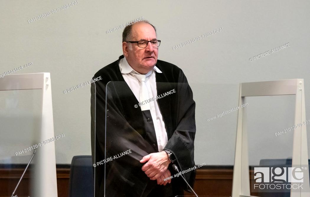 Stock Photo: 20 January 2021, North Rhine-Westphalia, Dortmund: Presiding judge Thomas Kelm stands between plexiglass panes in the regional court to protect against.