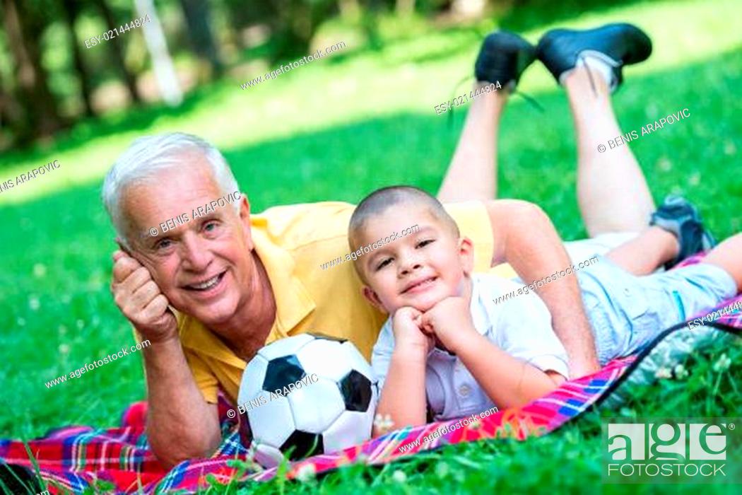 Stock Photo: grandfather and child have fun in park.