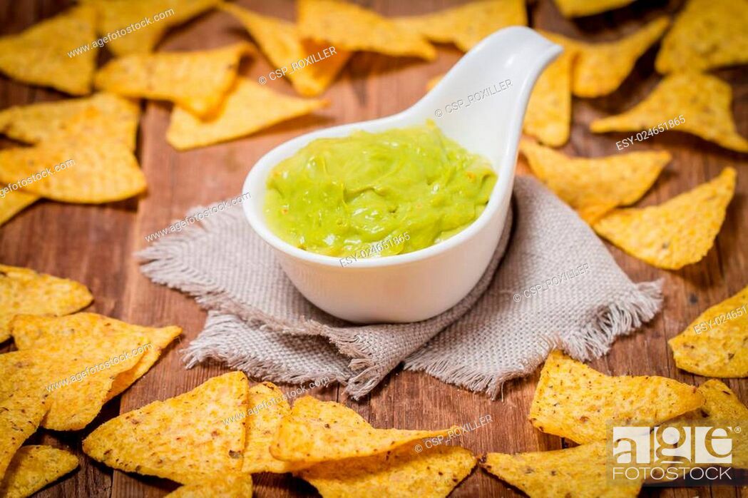 Stock Photo: Mexican nachos with handmade guacamole sauce.