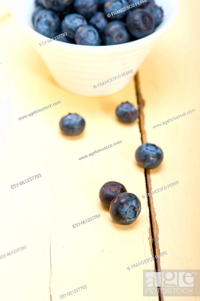 Stock Photo: fresh blueberry on a bowl with silver spoon over wood table.