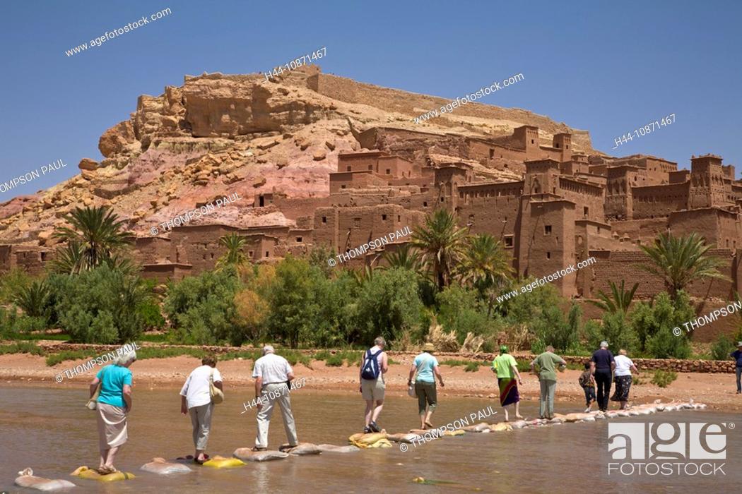 Stock Photo: Tourists crossing the river at Ait Ben Haddou Kasbah, Ouarzazate, Morocco.