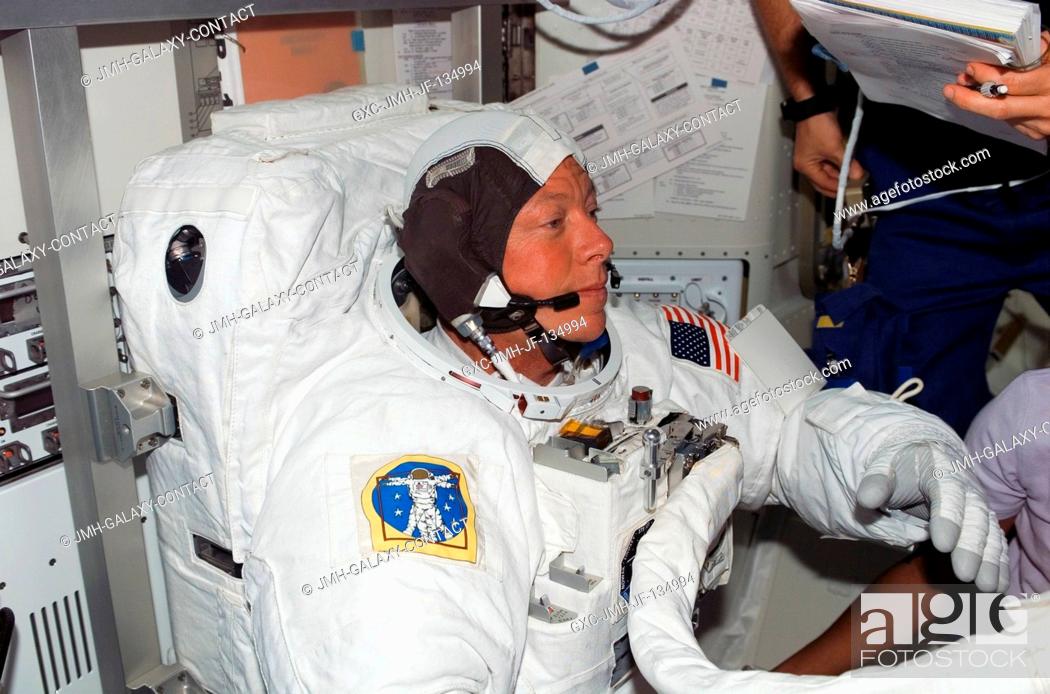 Stock Photo: Astronaut Michael E. Fossum, STS-121 mission specialist, attired in his Extravehicular Mobility Unit (EMU) spacesuit, prepares for the start of the mission's.