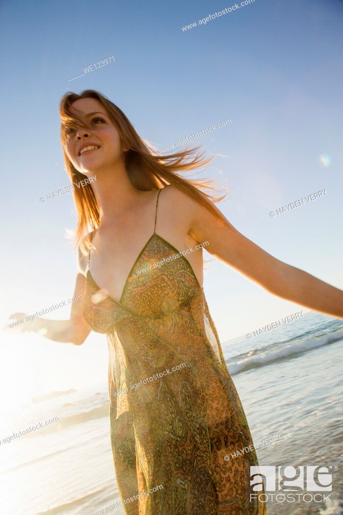 Stock Photo: Young Woman Celebrating On Beach.