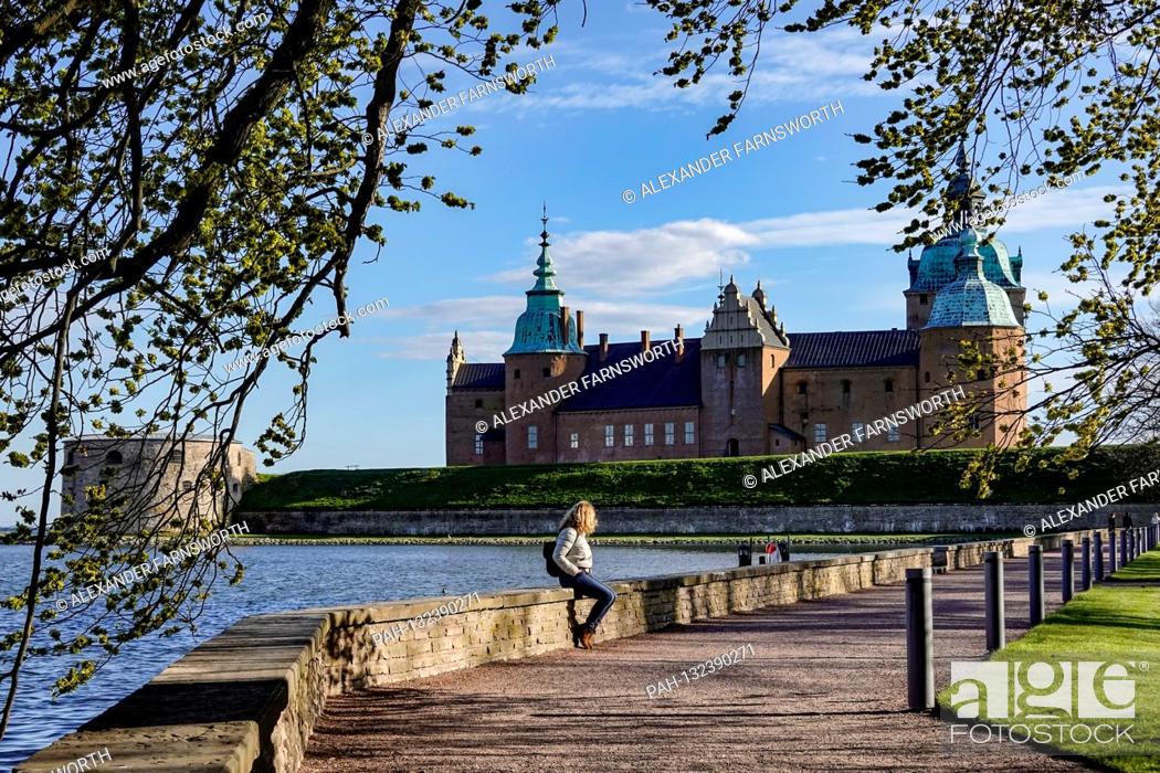 Stock Photo: Kalmar, Sweden A woman sits on a wall on the grounds of the Kalmar Castle. | usage worldwide. - KALMAR/Sweden.