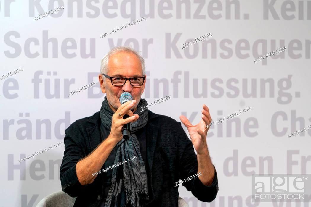Stock Photo: FRANKFURT AM MAIN, Germany - October 17 2019: Eugen Ruge (*1954, German writer and translator) talking on stage at 71st Frankfurt Book Fair / Buchmesse.