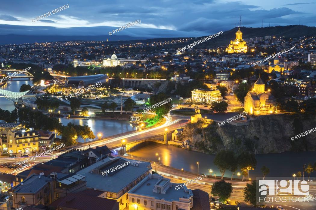 Stock Photo: Tbilisi, Georgia. Evening Night View Of Georgian Capital Skyline. Scenic Top View Of Summer Evening Cityscape Of Tbilisi.