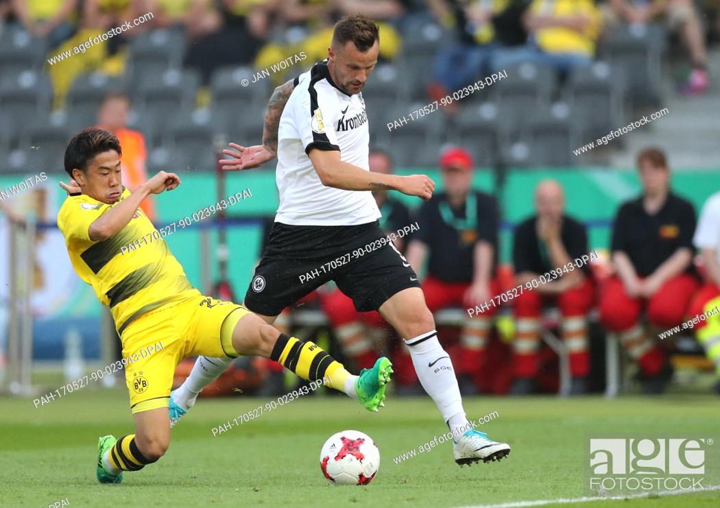 Stock Photo: Dortmund's Shinji Kagawa (L) and Frankfurt's Haris Seferovic (M) vie for the ball during the German DFB Cup final between Eintracht Frankfurt and Borussia.