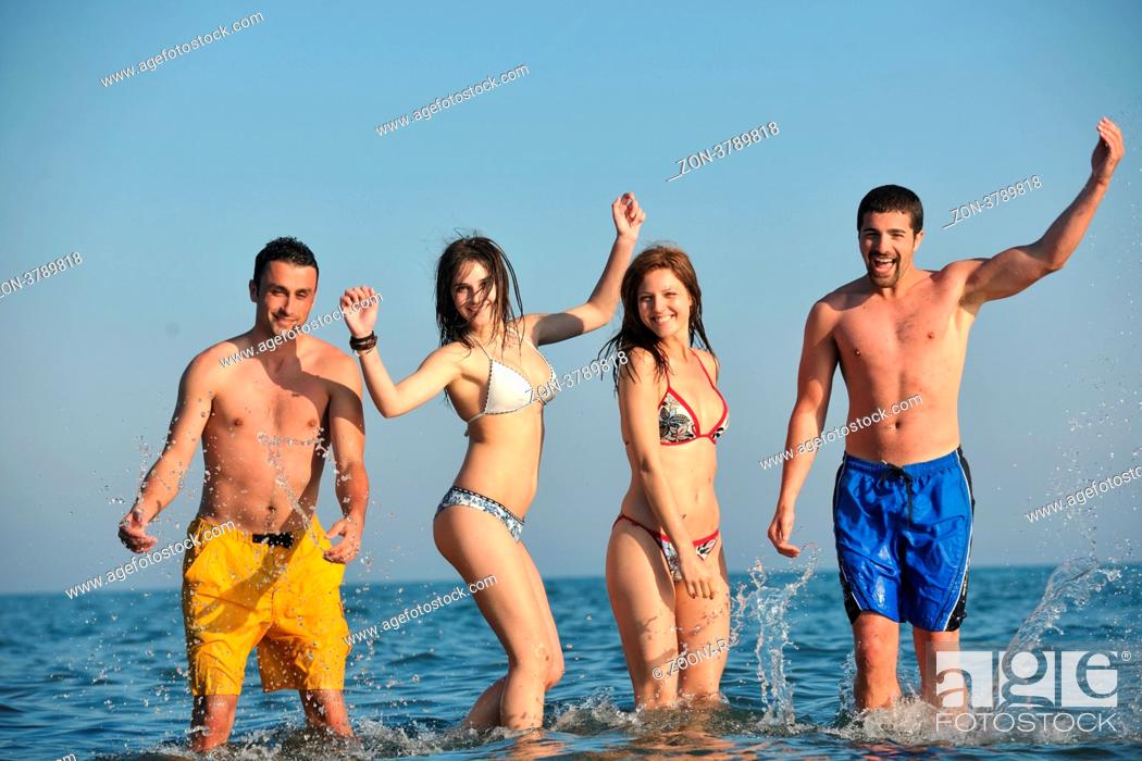 Stock Photo: happy people group have fun run and jump on beach beautiful sand beach.