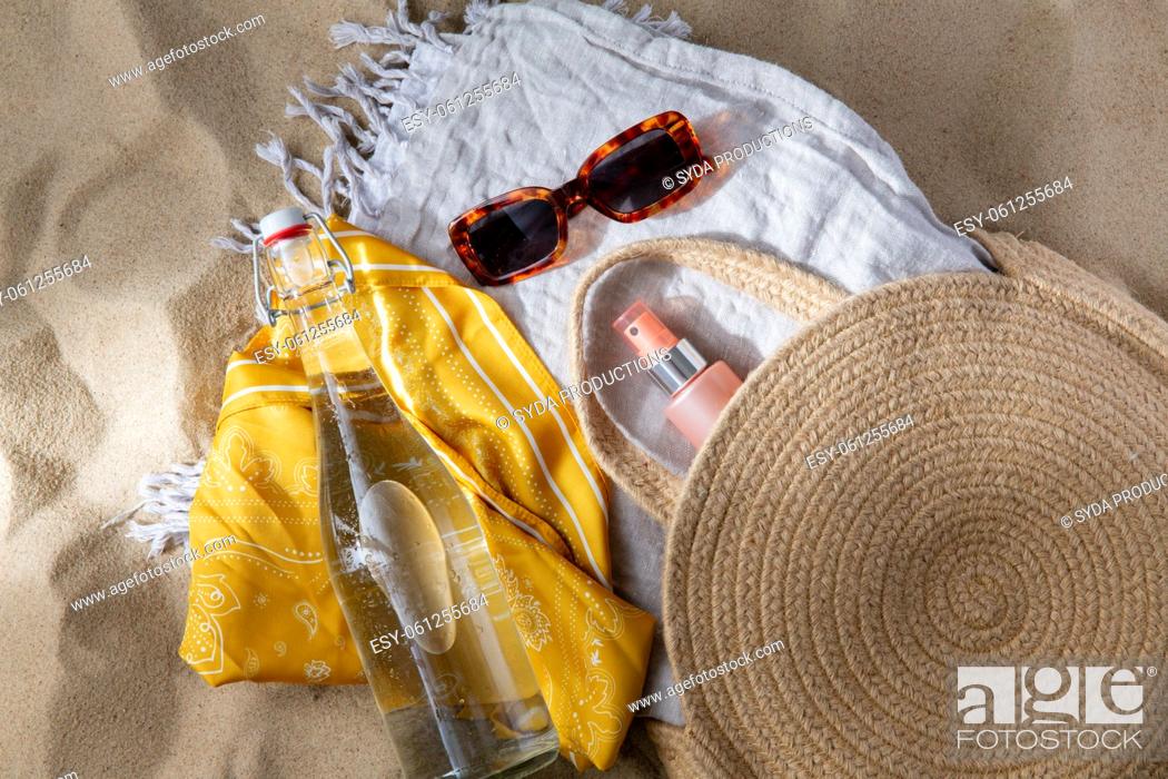 Stock Photo: sunglasses, bag, water bottle, sunscreen on beach.