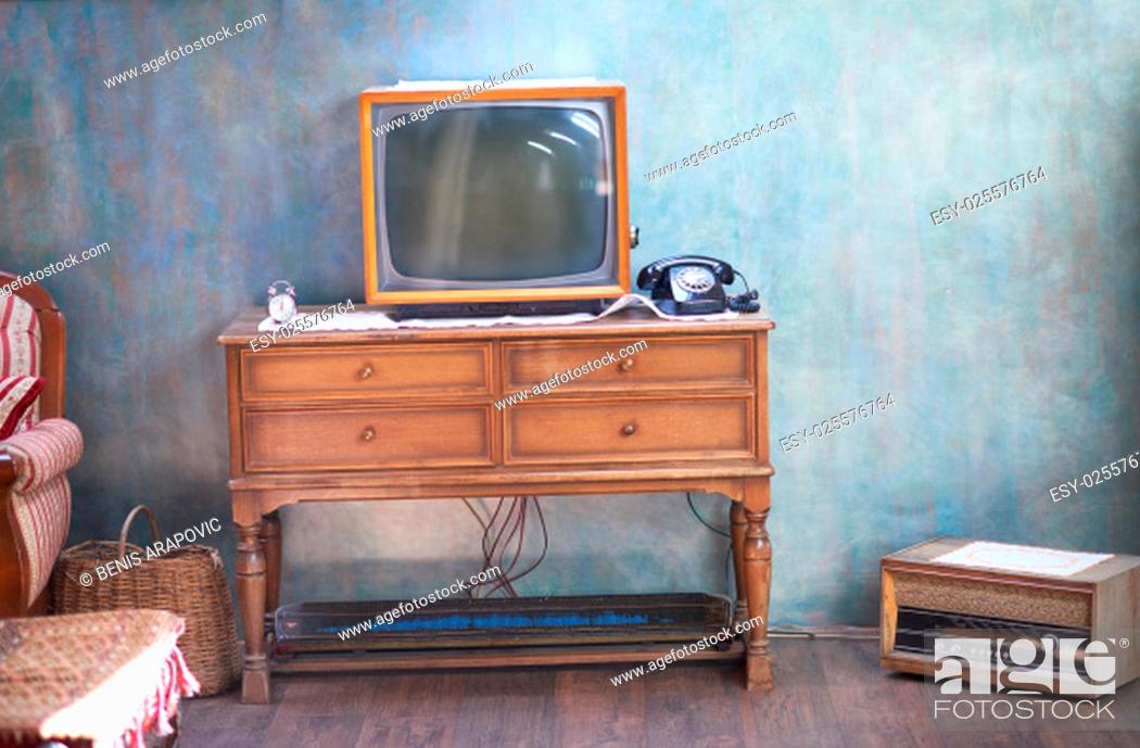 Stock Photo: Vintage retro look living room detail. Television, telephone and clock on wooden old table.
