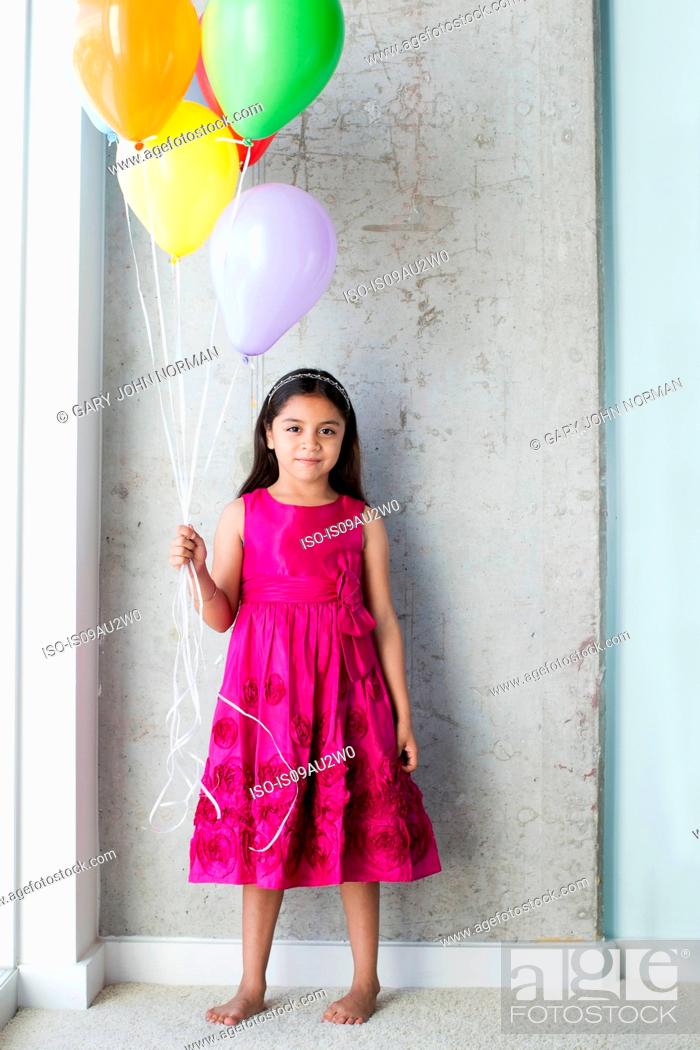 Stock Photo: Portrait of young girl holding balloons.