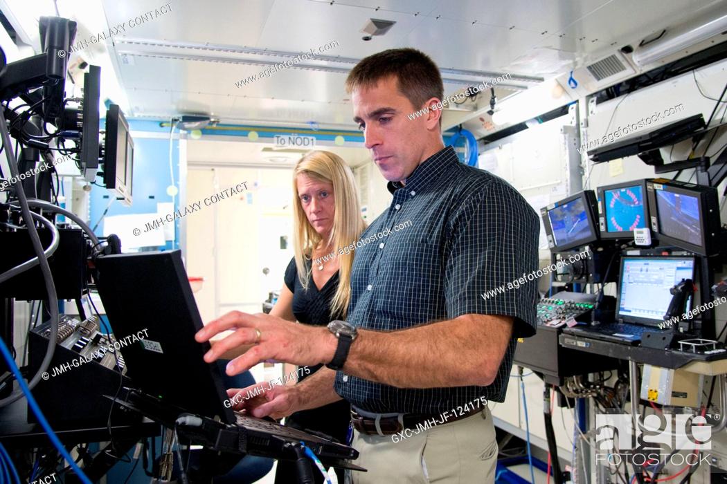 Stock Photo: NASA astronauts Chris Cassidy, Expedition 3536 flight engineer; and Karen Nyberg, Expedition 3637 flight engineer, participate in a robotics training session in.