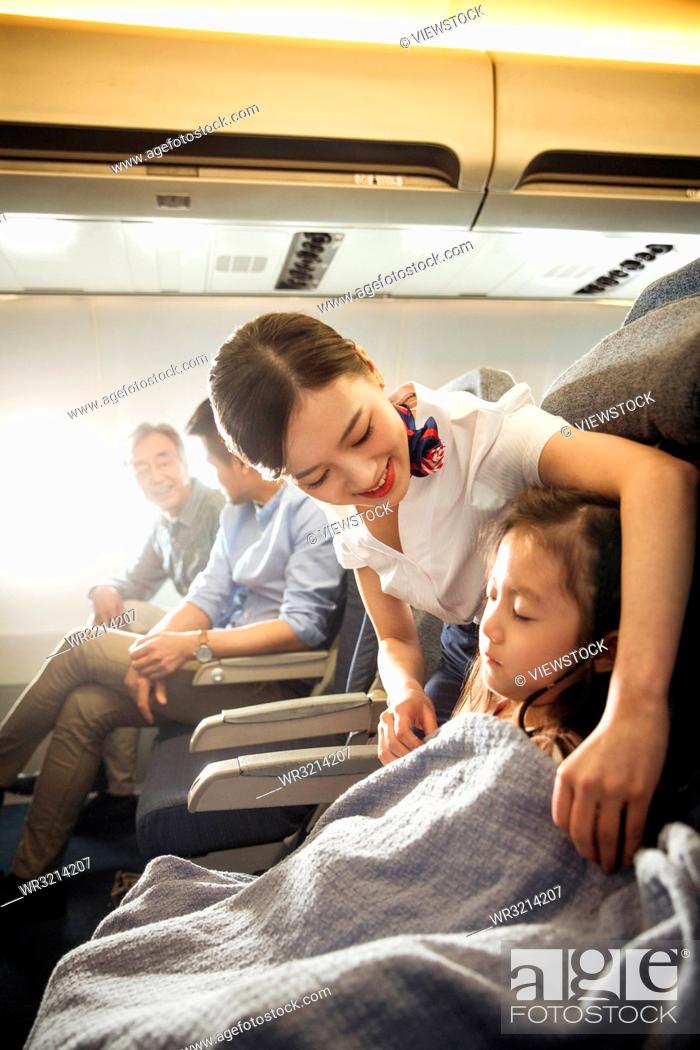 Stock Photo: Flight attendants and passengers on the plane.