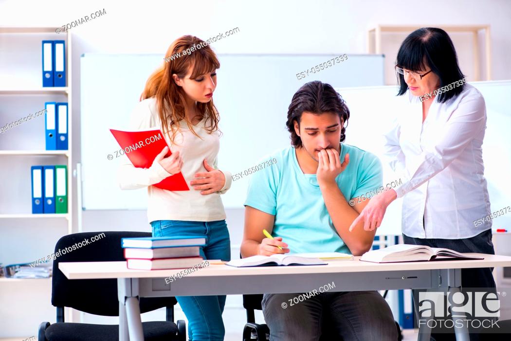 Stock Photo: The old teacher and students in the classroom.