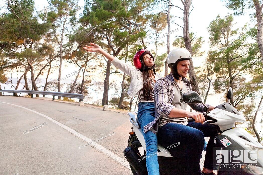 Stock Photo: Couples riding moped on rural road, Split, Dalmatia, Croatia.