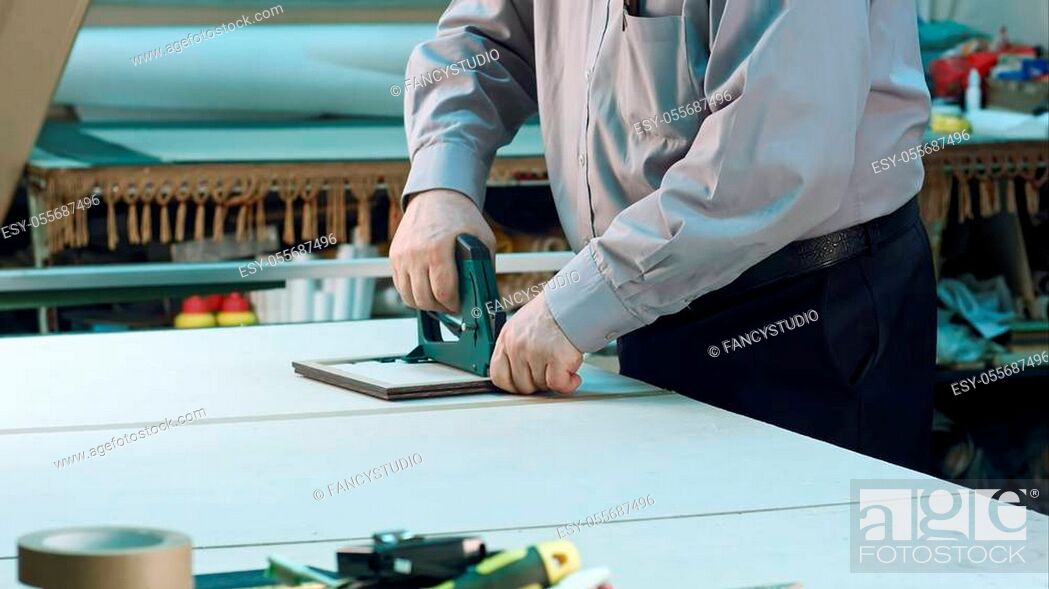Stock Photo: Senior worker finishing frame in workshop. Close up. Professional shot in 4K resolution. 083. You can use it e. g. in your commercial video, business.
