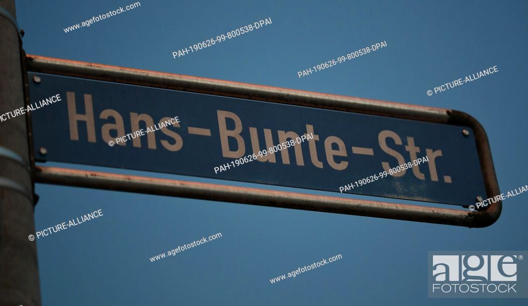 Stock Photo: 25 June 2019, Baden-Wuerttemberg, Freiburg: The street sign ""Hans-Bunte-Strasse"" hangs on a lantern pole. In mid-October 2018.