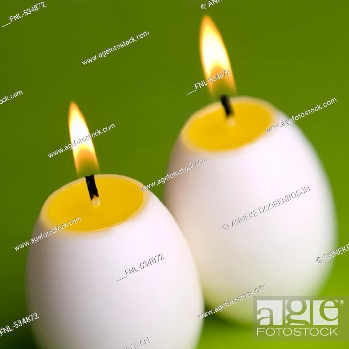 Stock Photo: Close-up of lit egg shaped candles.