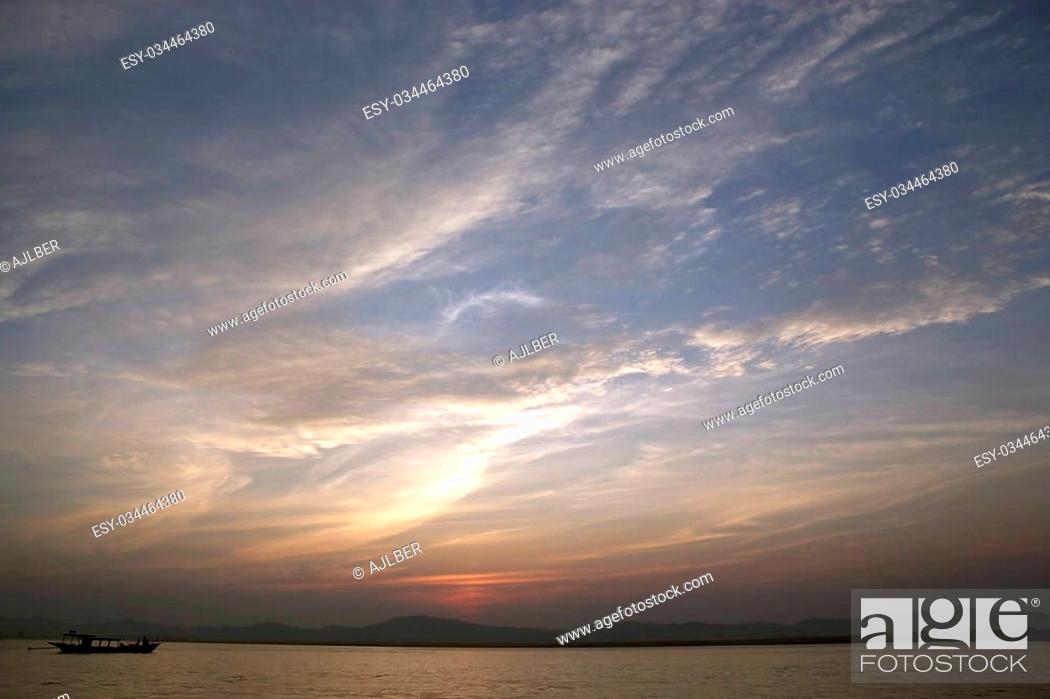 Stock Photo: Sunset on the Irrawaddy river in Bagan, Myanmar. Irrawaddy river flows from North to South in Myanmar. It is the Country largest river and most important.