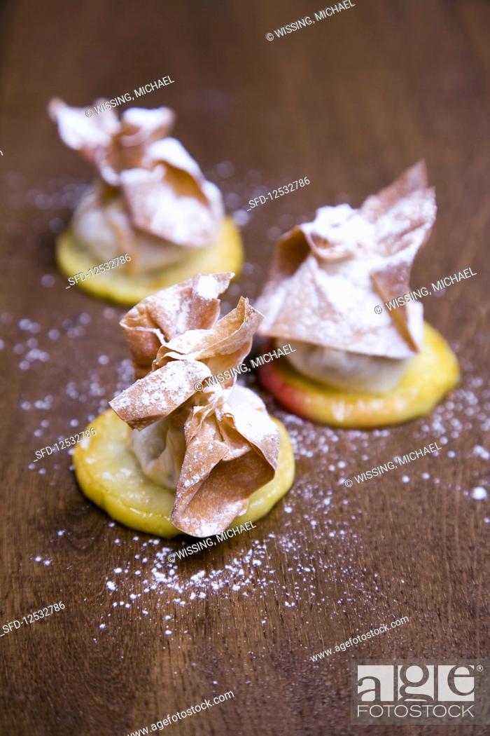 Stock Photo: Pear strudel on glazed apple slices.
