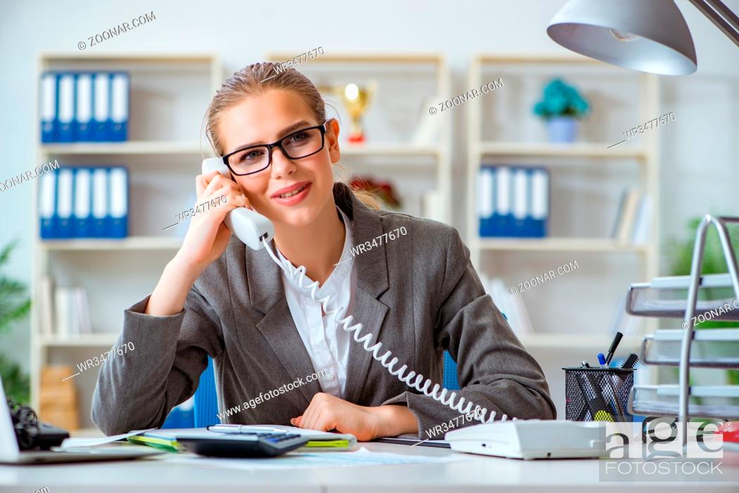 Stock Photo: Young businesswoman accountant working in the office.